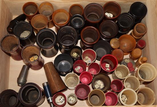 A collection of 19th century ivory, bone and treen etc. dice shakers and containers, many with bone dice